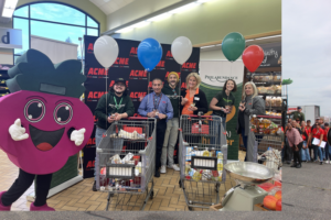 a group of people standing in a grocery store